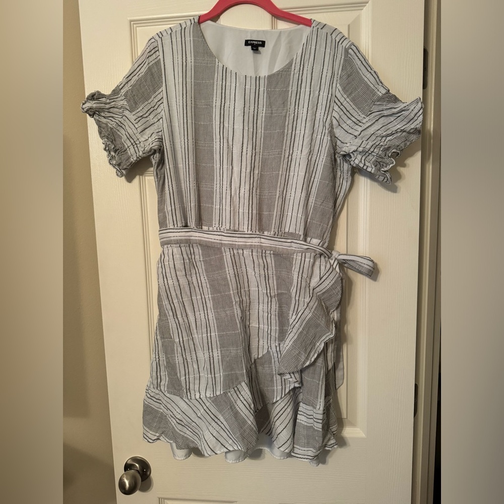 Dress with a wrap around component to the skirt.